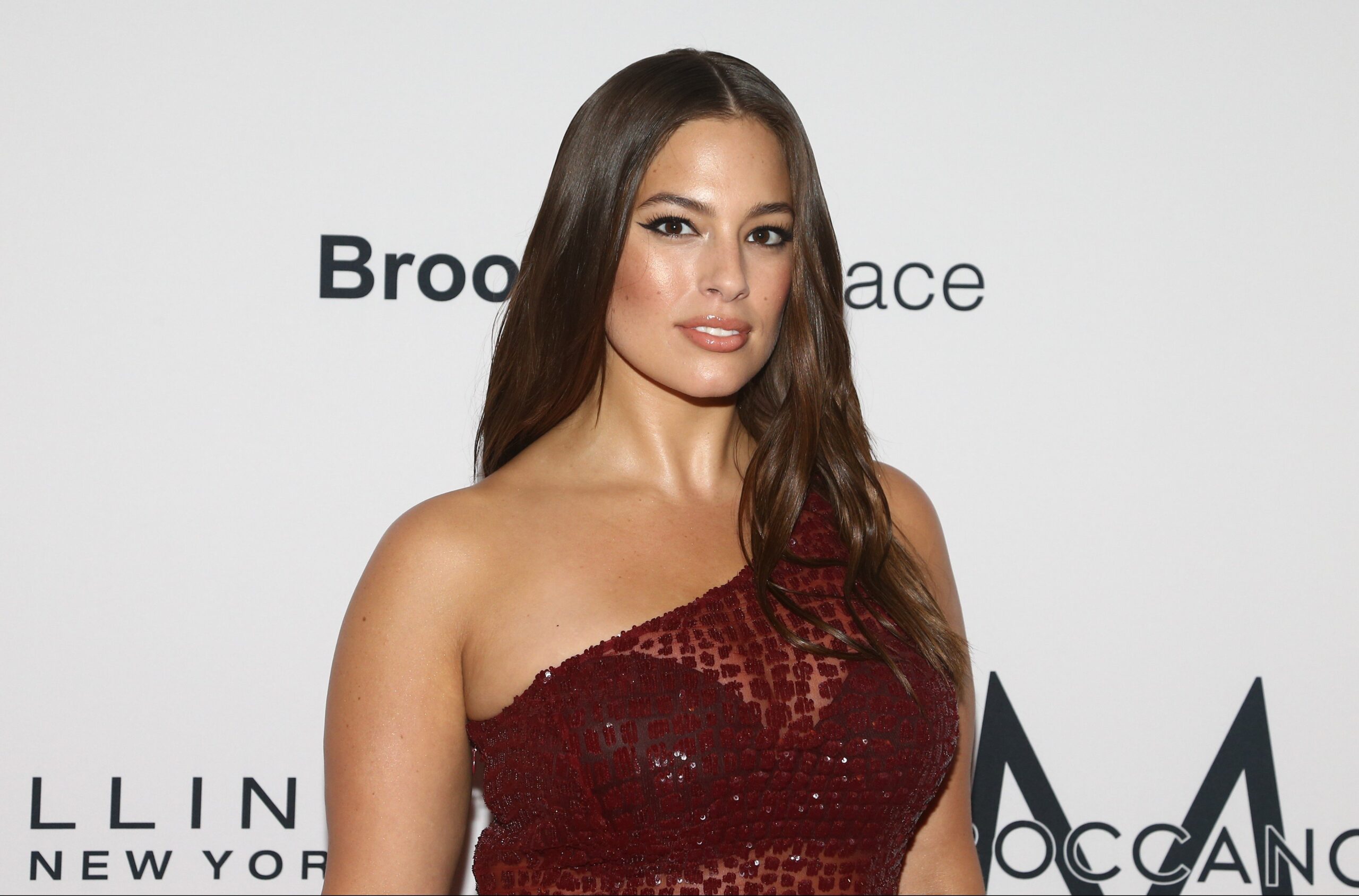 Ashley Graham wearing a see-through red dress on the red carpet
