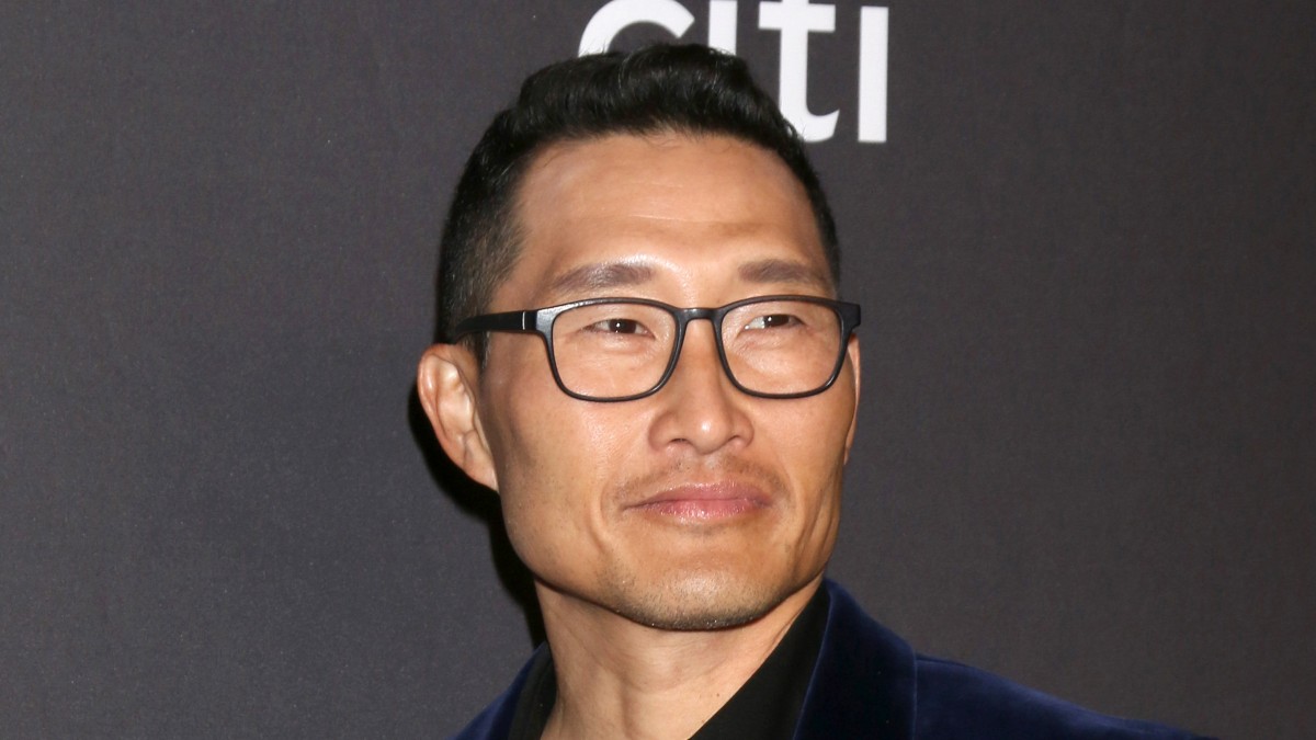 Daniel Dae Kim wears a blue velvet suit against a dark background