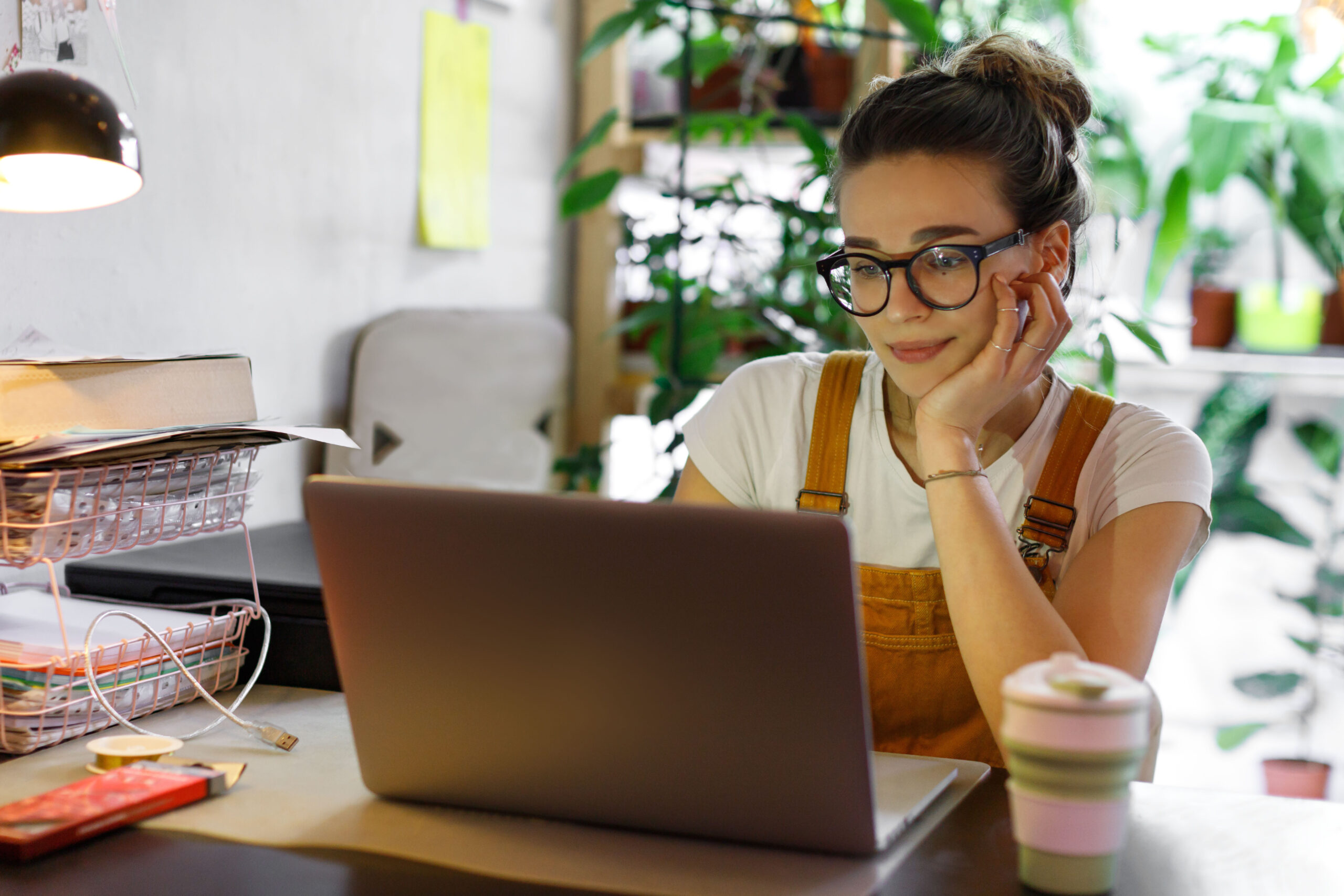 Image of young woman working from home.