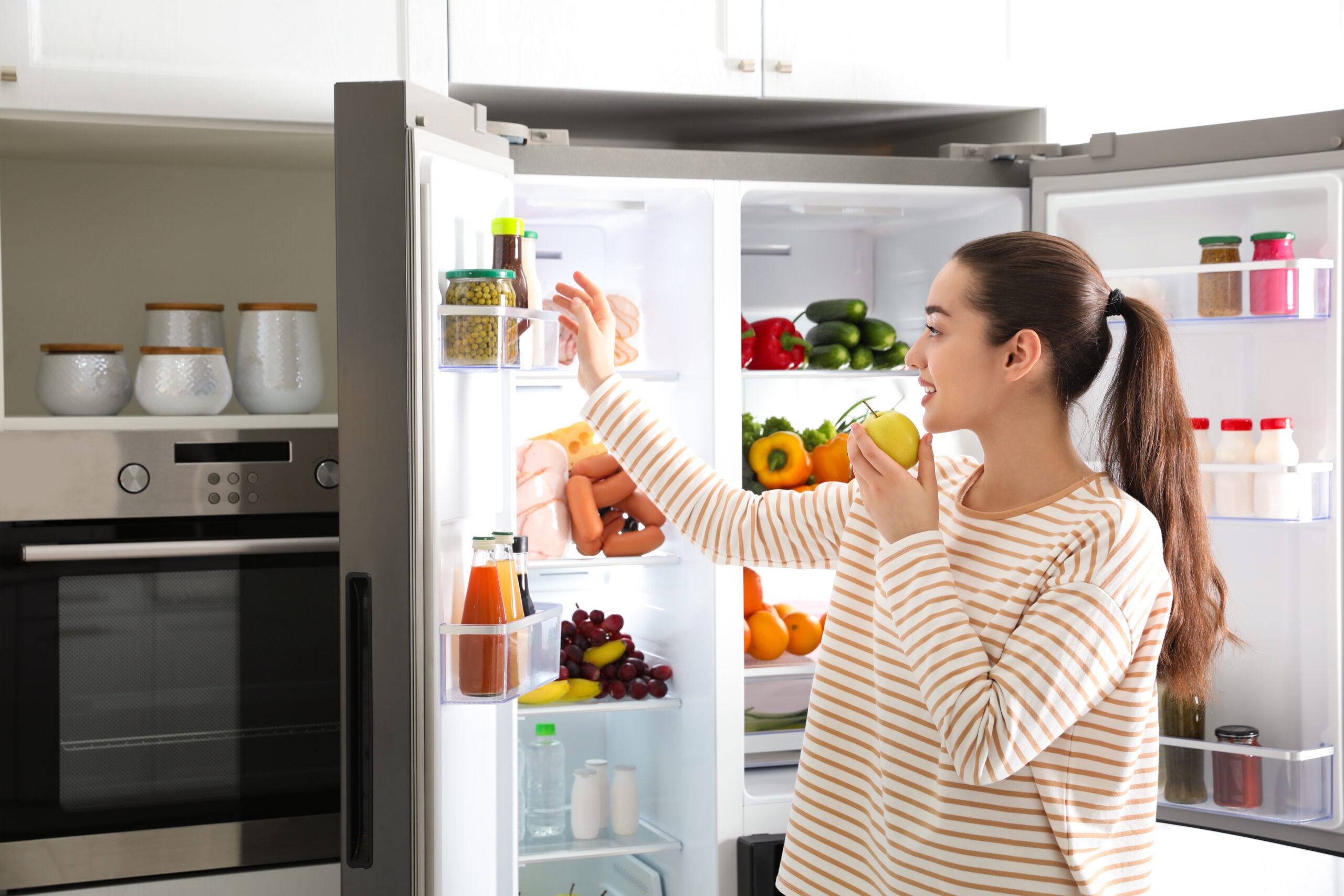 Woman looking in the fridge.