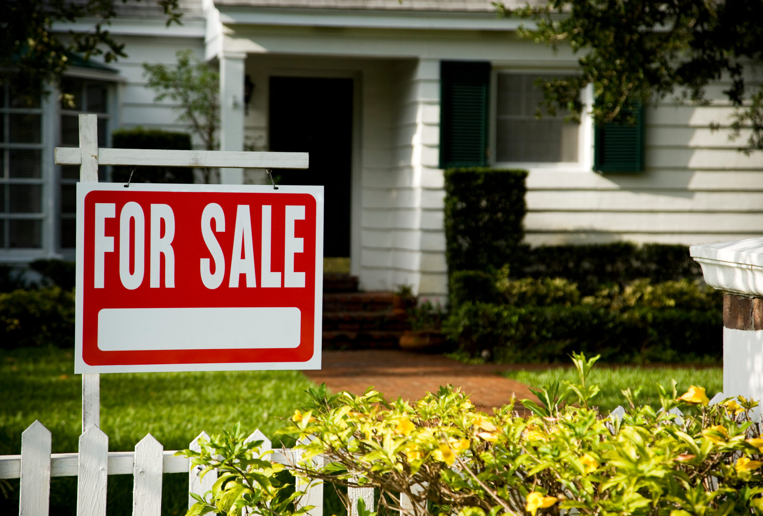 A 'For Sale' sign outside a home.