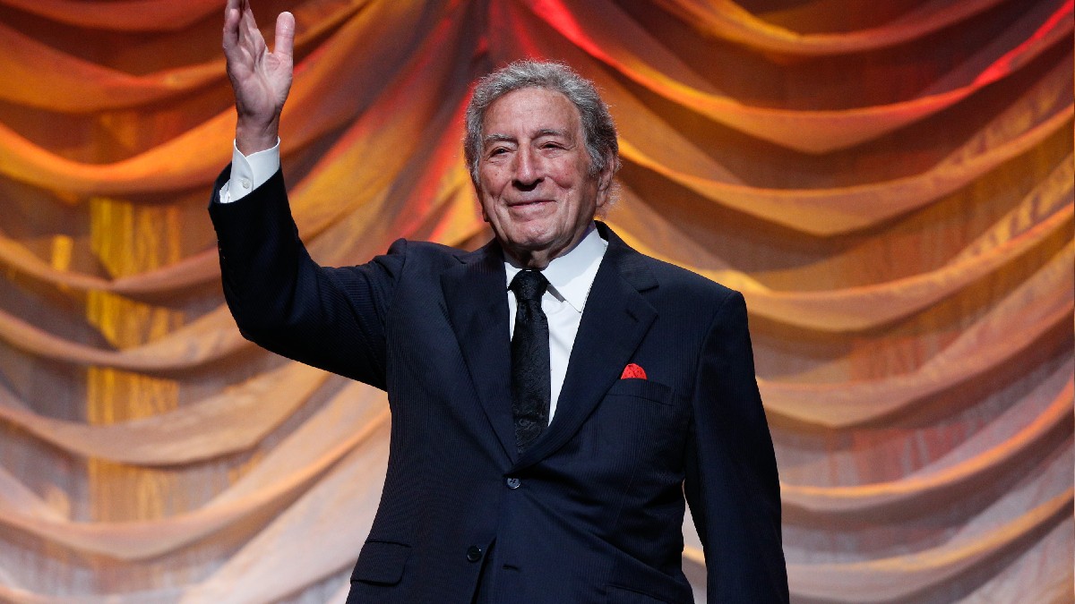 Tony Bennett wears a dark suit onstage