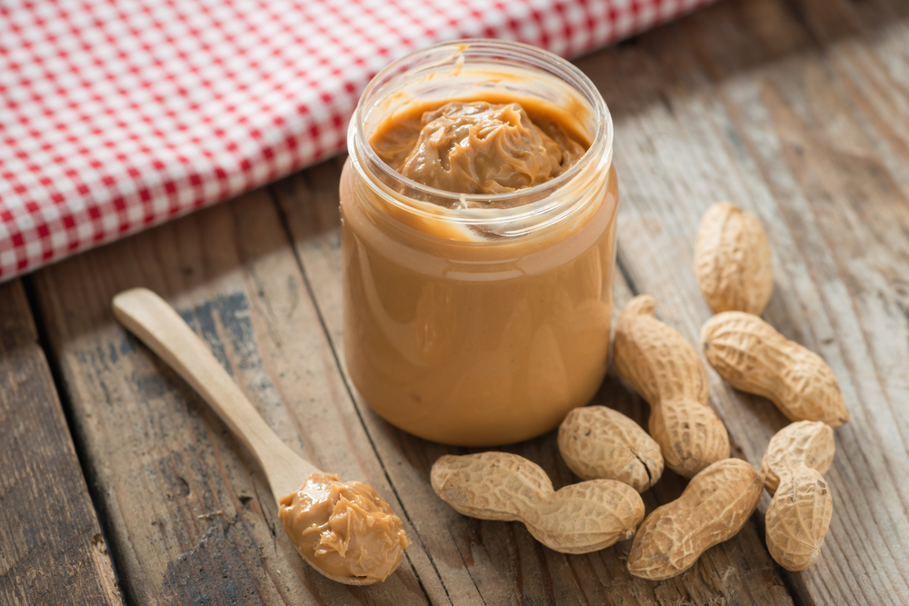 Open jar of peanut butter. 