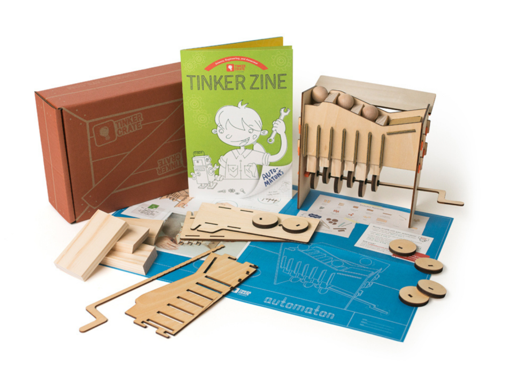 KiwiCo tinker box with various wooden pieces, diagrams, and booklets 