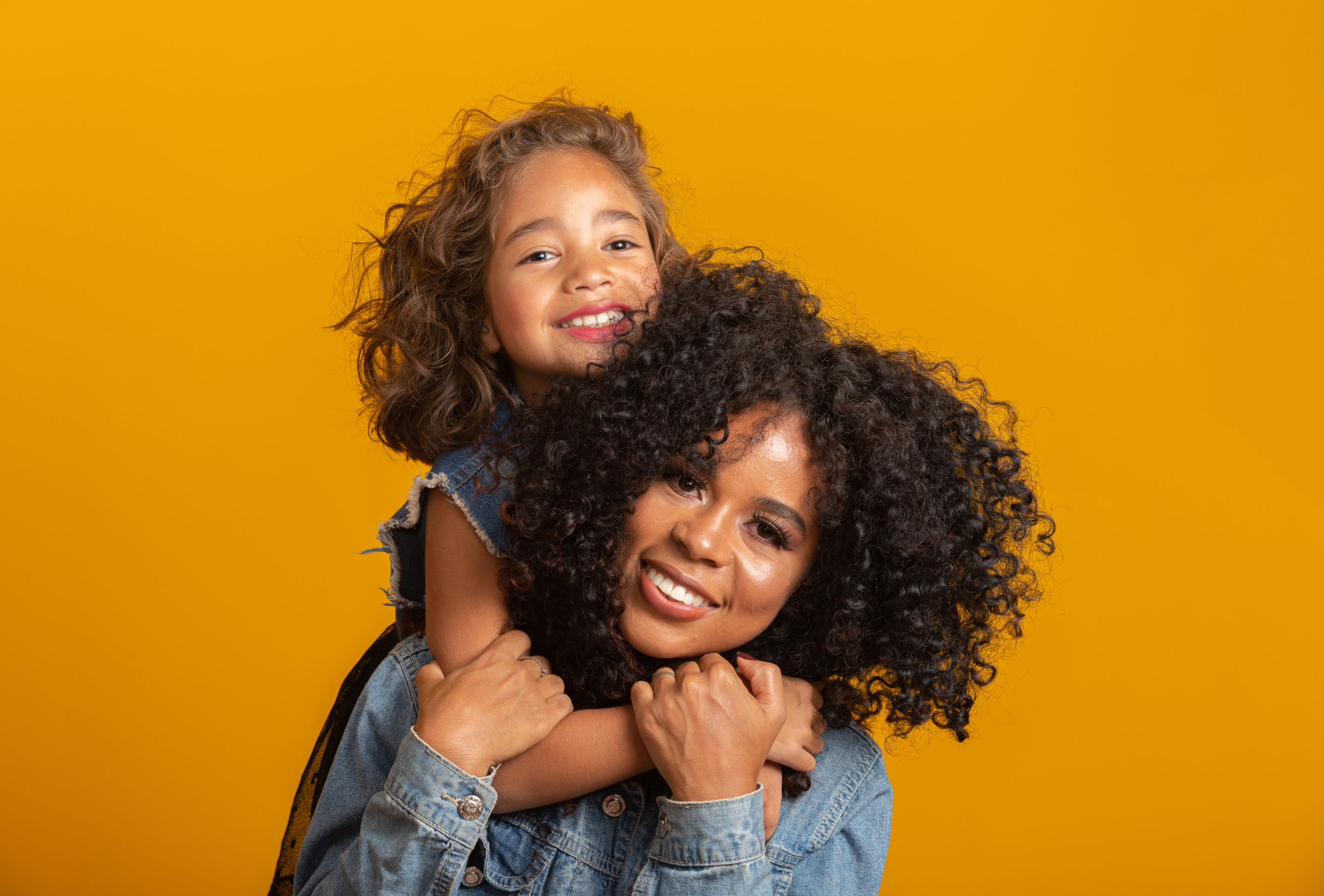 Smiling mother and daughter hugging