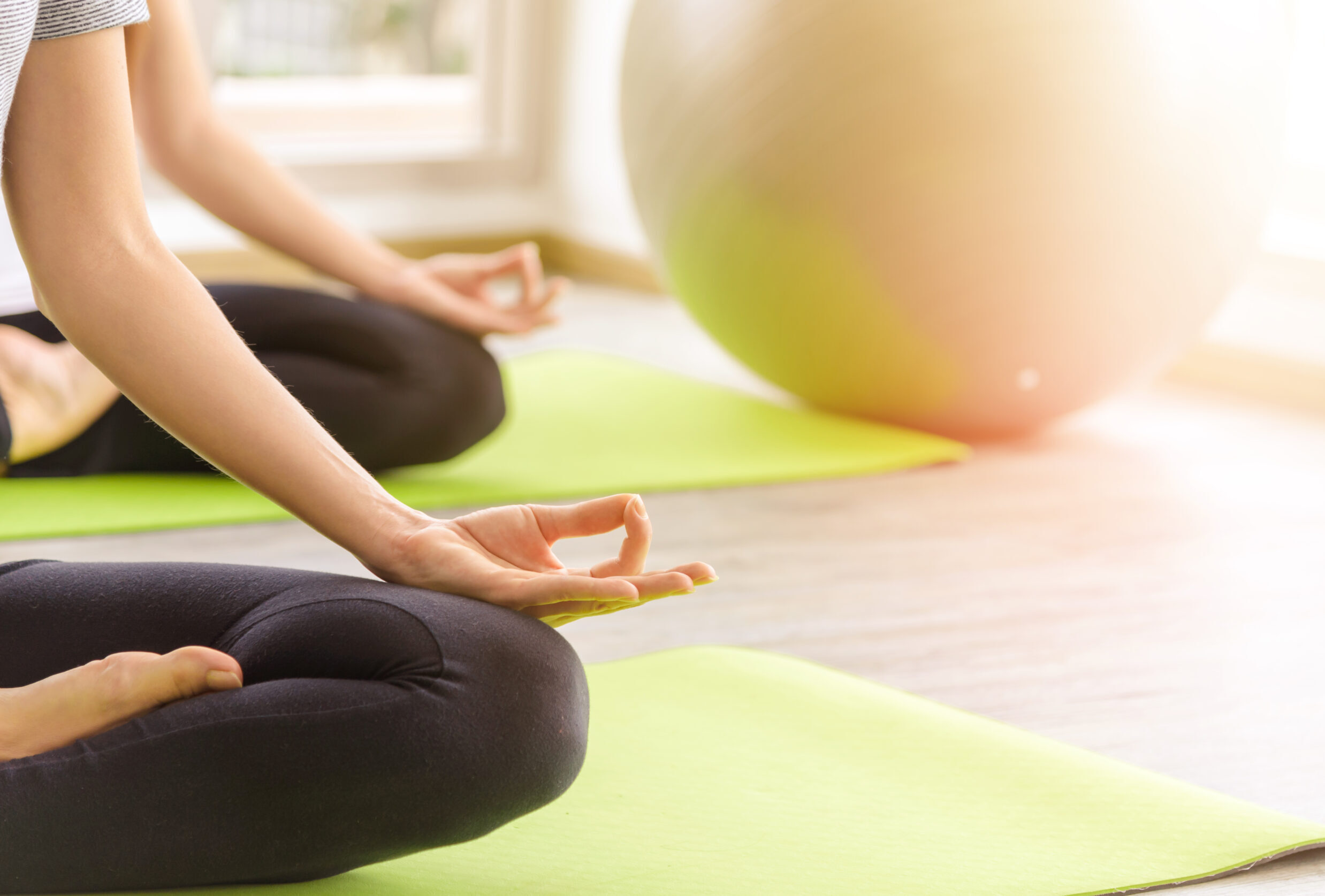 Women meditating on yoga mats.