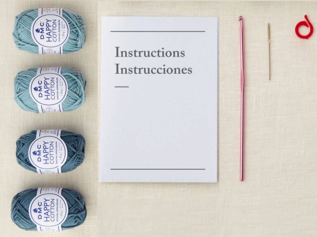 DMC crochet kit yarn, instruction booklet, and tools