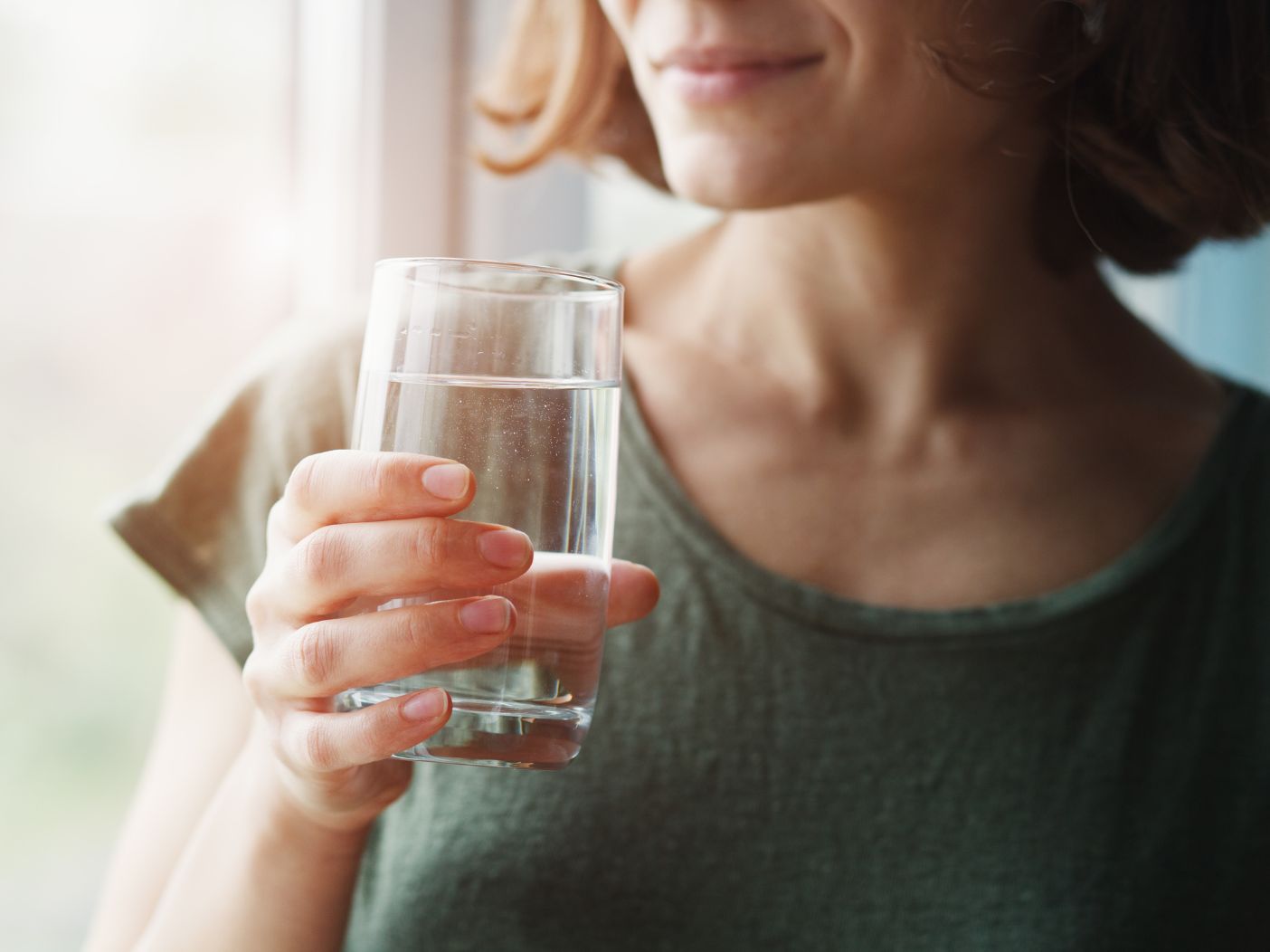 Woman holding glass of water