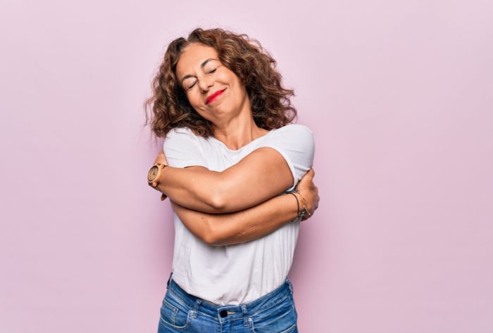 Woman hugging herself