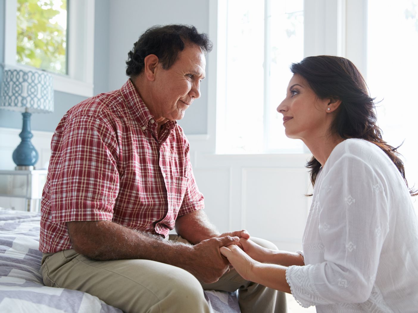 Adult daughter comforting grieving father