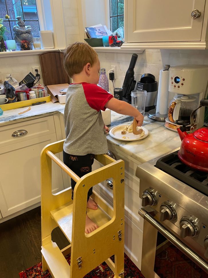 Grelle's two-year-old son standing on the Mini Chef Convertible Helper Tower