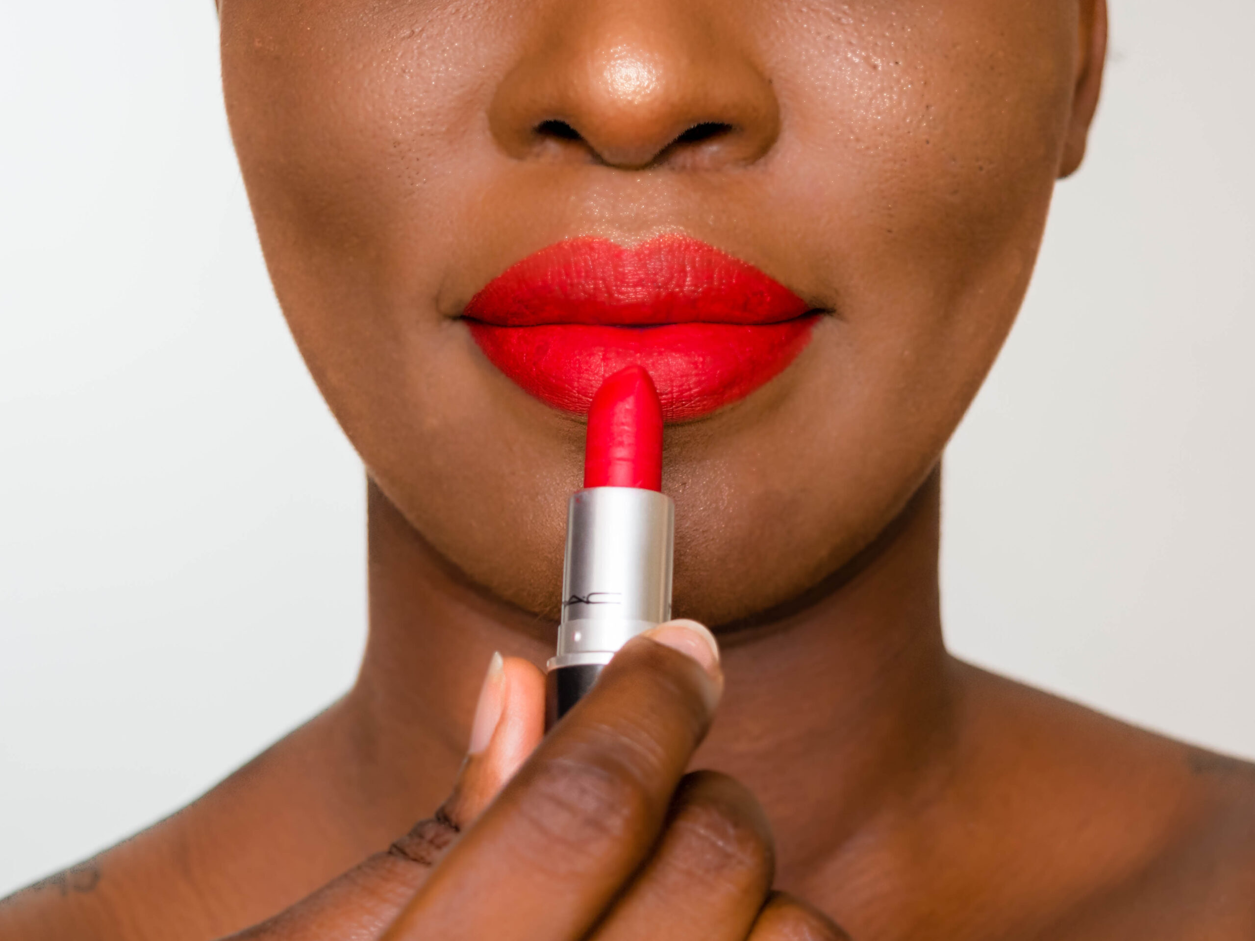 Woman applying red lipstick