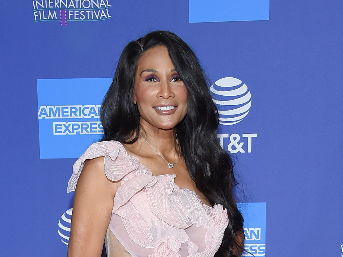 Beverly Johnson smiling in a pink ruffled dress