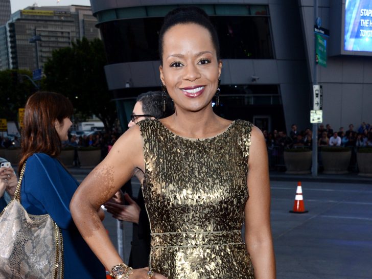 Tempestt Bledsoe smiles in gold sequined dress