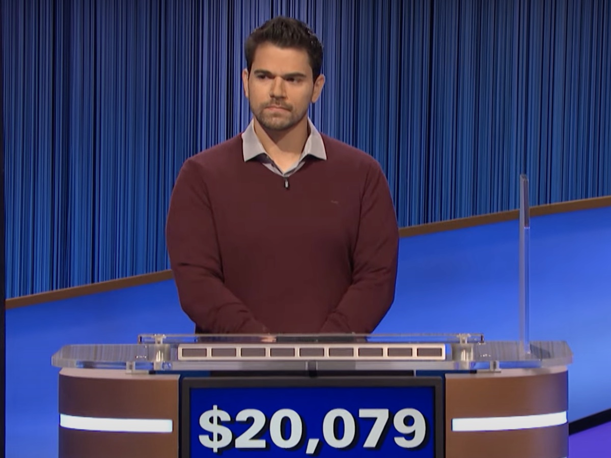 screenshot of Cris Pannullo competing on Jeopardy! looking serious with hands clasped