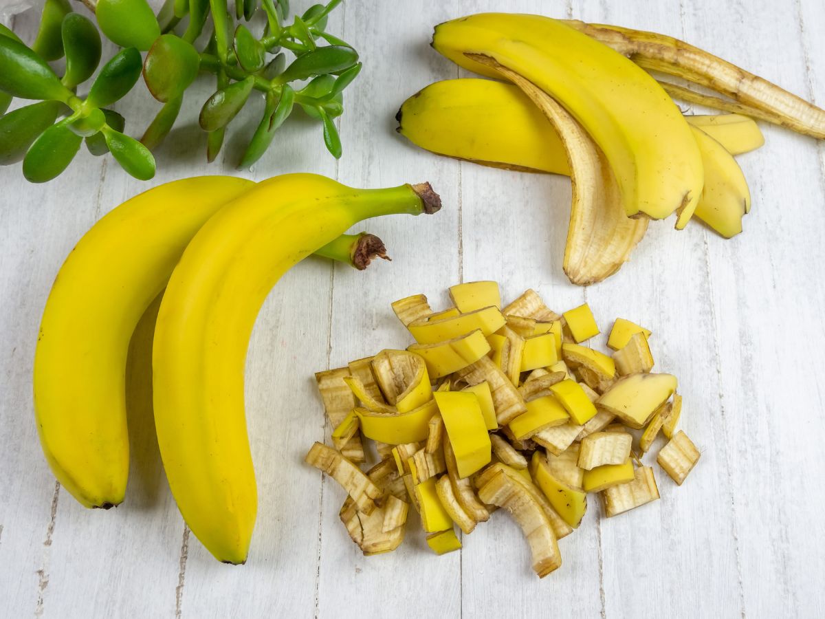 Chopped banana peels next to bananas, whole banana peels