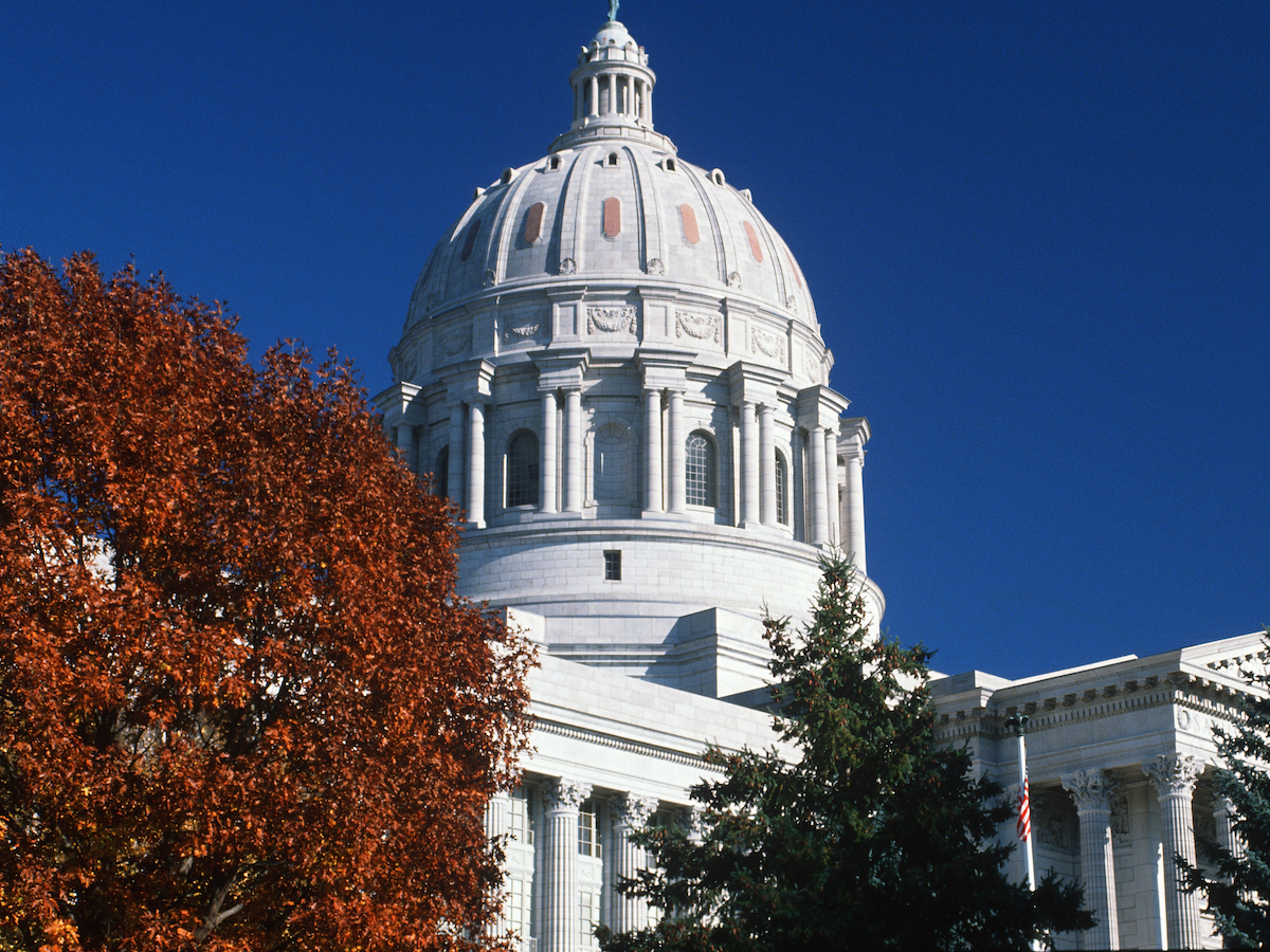 photo of the Missouri Captiol from the ground looking up at its dome against a blue sky